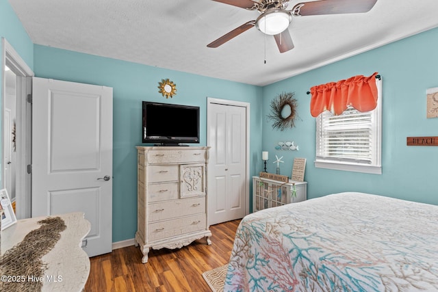 169 NW 7th St, Oak Island, NC 28465 - bedroom featuring a closet, wood finished floors, a ceiling fan, and baseboards
