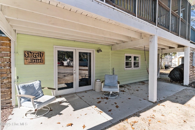 169 NW 7th St, Oak Island, NC 28465 - view of patio featuring french doors