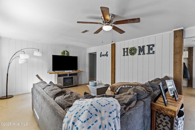 169 NW 7th St, Oak Island, NC 28465 - living room featuring finished concrete flooring, ceiling fan, and a fireplace