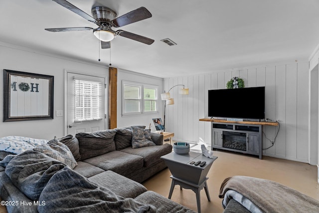 169 NW 7th St, Oak Island, NC 28465 - living area with a ceiling fan, a fireplace, and wooden walls