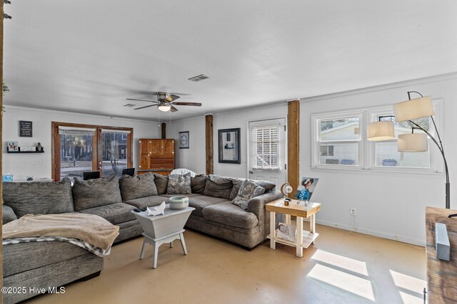 169 NW 7th St, Oak Island, NC 28465 - living room with finished concrete floors, healthy amount of natural light, a ceiling fan, crown molding, and baseboards