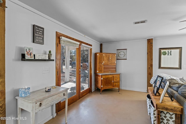 169 NW 7th St, Oak Island, NC 28465 - sitting room featuring french doors, concrete flooring, crown molding, and ceiling fan