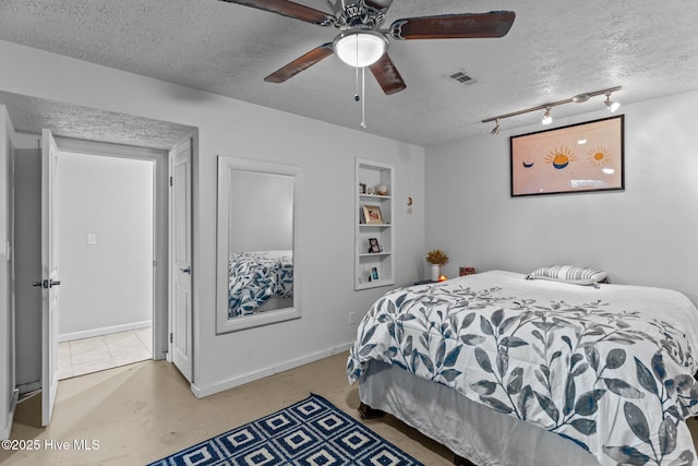 169 NW 7th St, Oak Island, NC 28465 - bedroom with a textured ceiling, track lighting, baseboards, and a ceiling fan