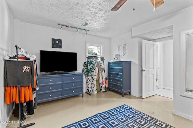 169 NW 7th St, Oak Island, NC 28465 - bedroom featuring a textured ceiling, finished concrete floors, a ceiling fan, and baseboards
