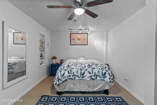 169 NW 7th St, Oak Island, NC 28465 - bedroom with a textured ceiling, concrete flooring, baseboards, and ceiling fan