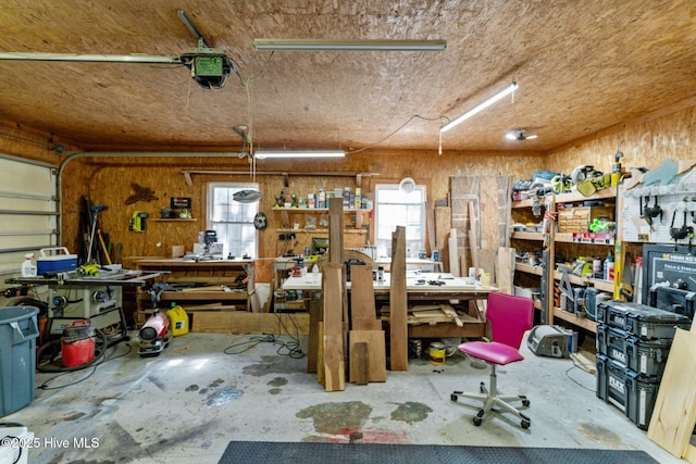 169 NW 7th St, Oak Island, NC 28465 - garage featuring a workshop area, a garage door opener, and wooden walls