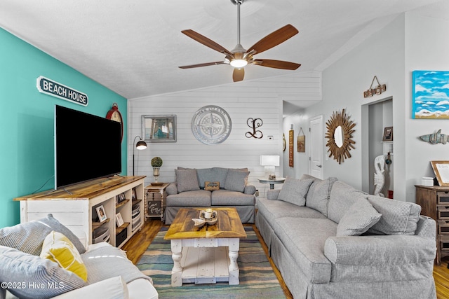 169 NW 7th St, Oak Island, NC 28465 - living room featuring vaulted ceiling, wood finished floors, a ceiling fan, and wooden walls