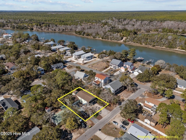 169 NW 7th St, Oak Island, NC 28465 - aerial perspective of suburban area with a heavily wooded area, a large body of water, and property boundaries highlighted