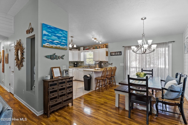169 NW 7th St, Oak Island, NC 28465 - dining room with wood finished floors and a chandelier