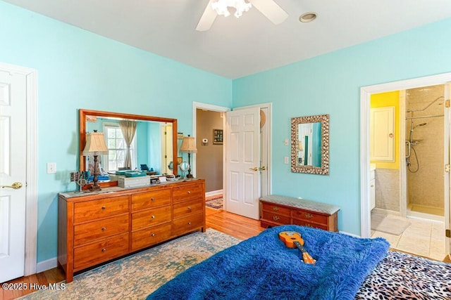 bedroom featuring connected bathroom, baseboards, and a ceiling fan