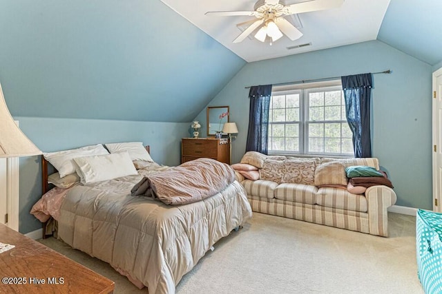 bedroom with light carpet, visible vents, baseboards, vaulted ceiling, and a ceiling fan