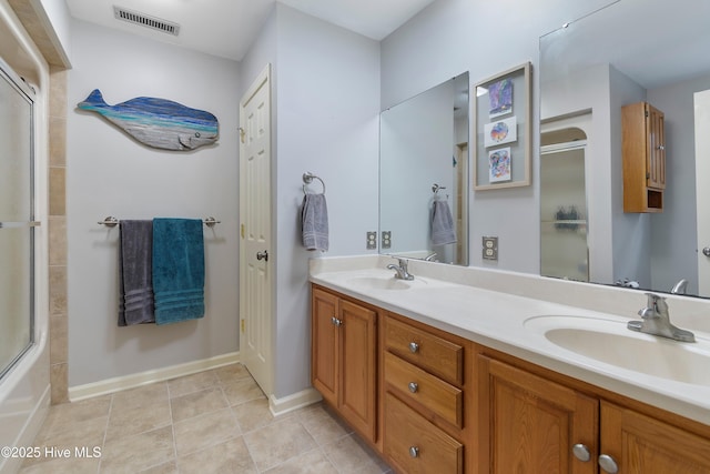 103 Ridge Rd, Hampstead, NC 28443 - full bathroom with an enclosed shower, double vanity, tile patterned flooring, and baseboards