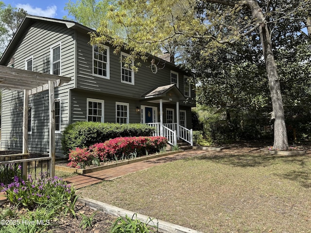 103 Ridge Rd, Hampstead, NC 28443 - view of front of house featuring a front yard and a chimney
