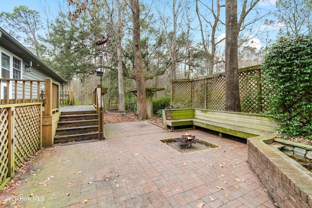 103 Ridge Rd, Hampstead, NC 28443 - view of patio / terrace featuring a wooden deck and a fire pit