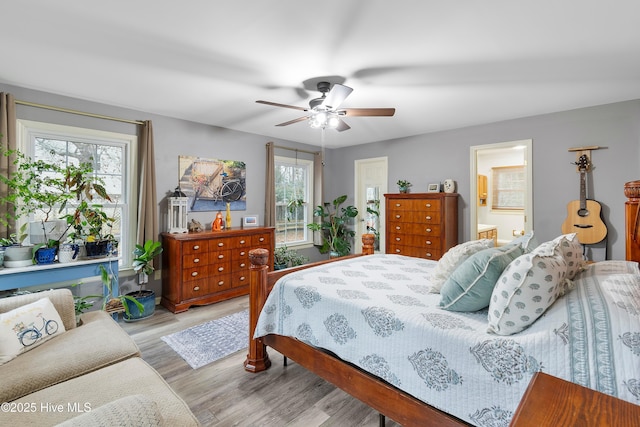 103 Ridge Rd, Hampstead, NC 28443 - bedroom with multiple windows, light wood-style floors, a ceiling fan, and ensuite bathroom