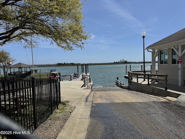 103 Ridge Rd, Hampstead, NC 28443 - dock area with a boat ramp, a water view, and fence