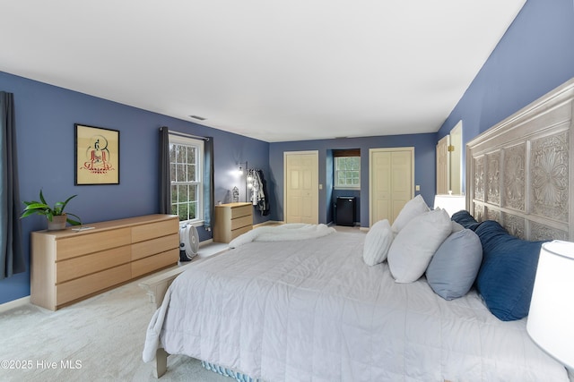103 Ridge Rd, Hampstead, NC 28443 - bedroom with multiple closets, light colored carpet, and baseboards