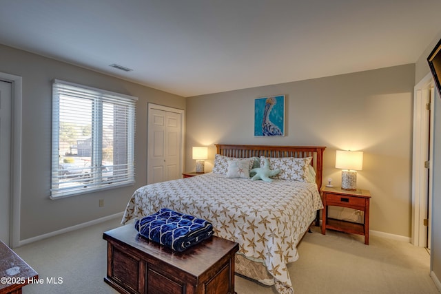 bedroom featuring visible vents, baseboards, and light colored carpet