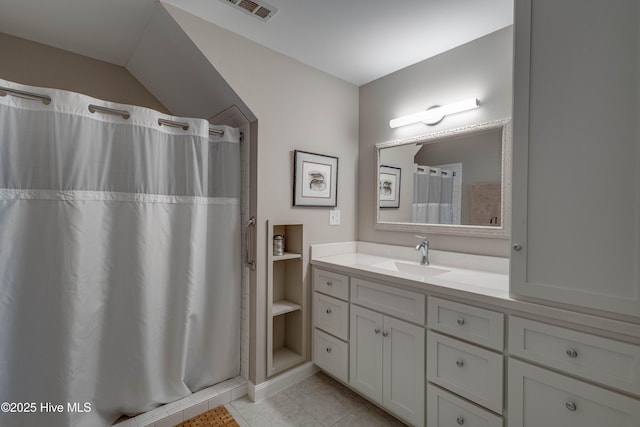 full bathroom with curtained shower, tile patterned flooring, visible vents, and vanity