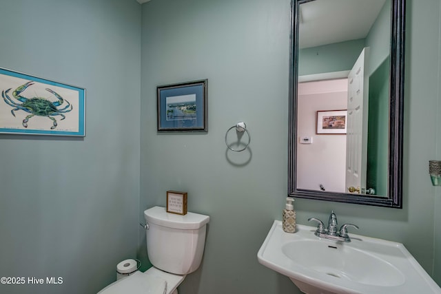 bathroom with toilet and a sink