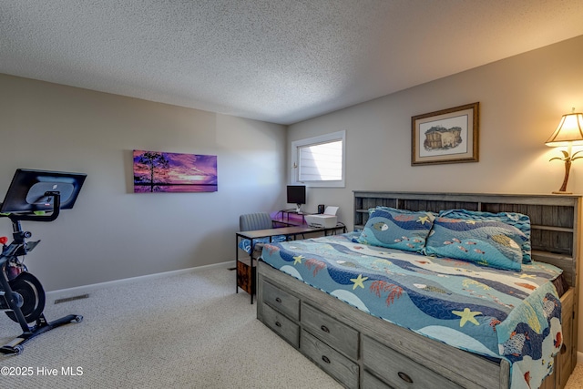 carpeted bedroom featuring baseboards and a textured ceiling