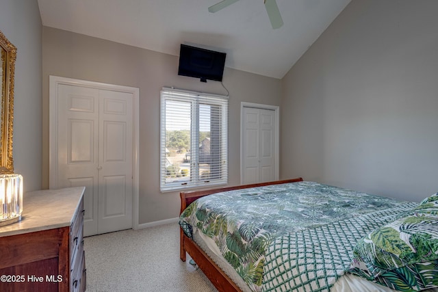 bedroom with light colored carpet, ceiling fan, baseboards, and vaulted ceiling