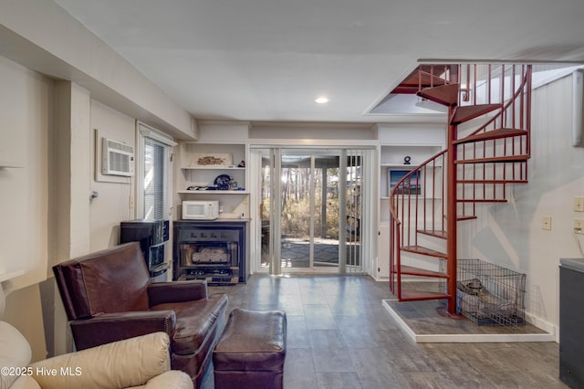 living room with recessed lighting, stairs, an AC wall unit, and wood finished floors