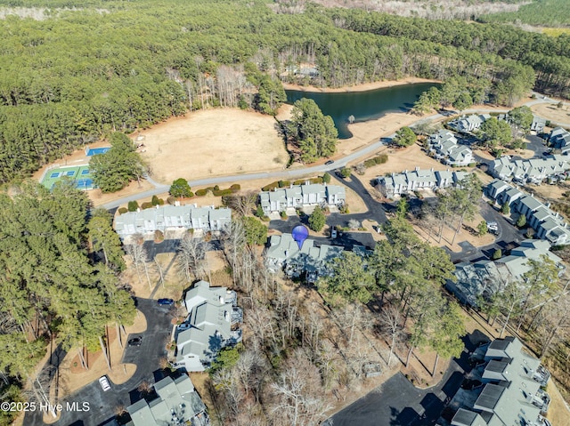 aerial view featuring a view of trees and a water view