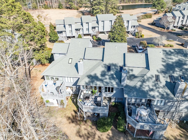 bird's eye view with a residential view and a water view