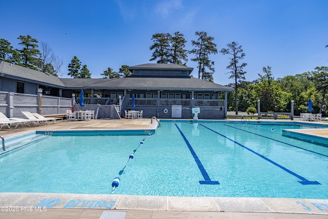 pool featuring a patio and fence