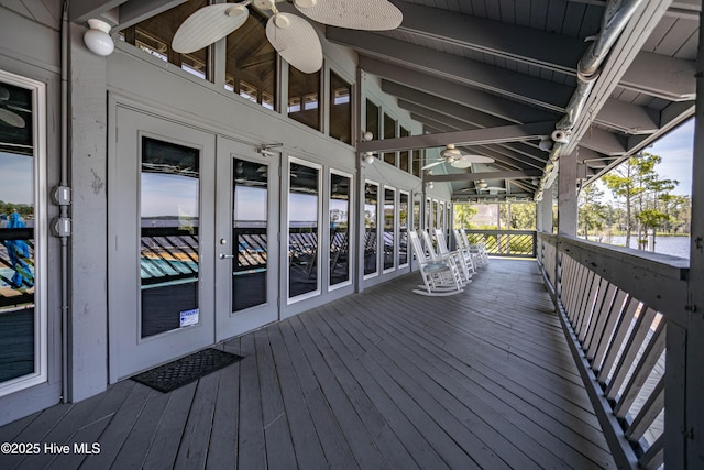 wooden deck with a ceiling fan and french doors