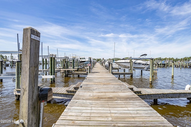 dock area with a water view and boat lift