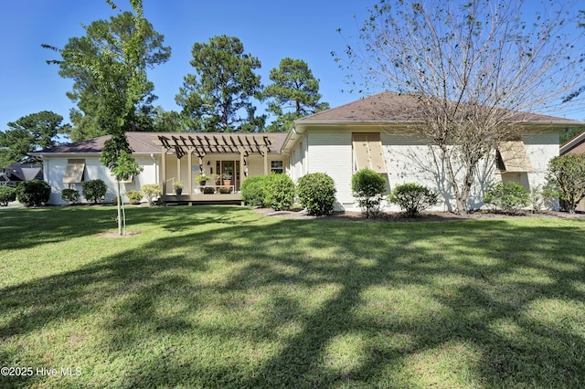 view of front of house with a front lawn and a pergola
