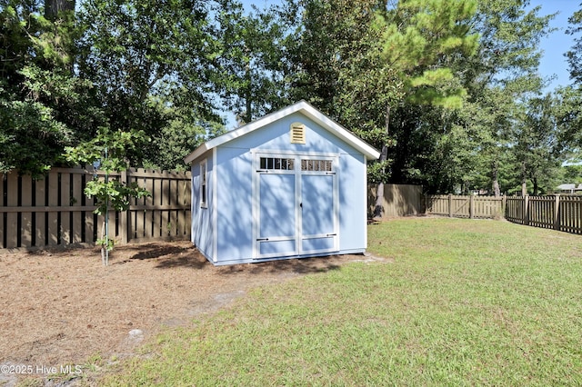 view of shed with a fenced backyard