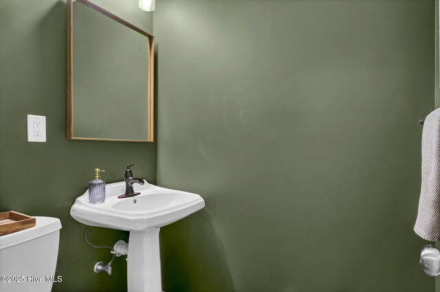 half bathroom featuring toilet