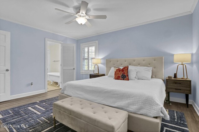 bedroom featuring ornamental molding, baseboards, and wood finished floors