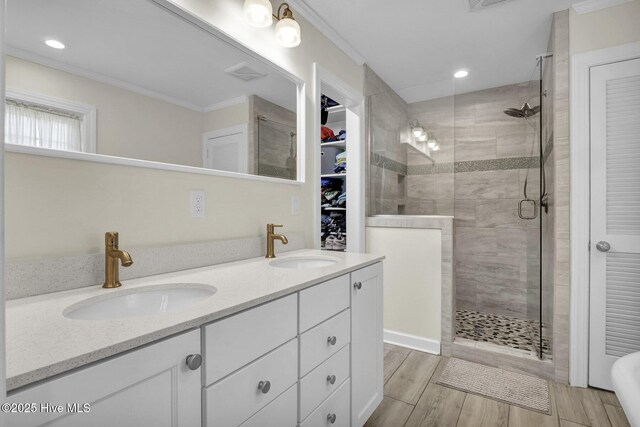 full bath featuring a shower stall, wood finish floors, and a sink