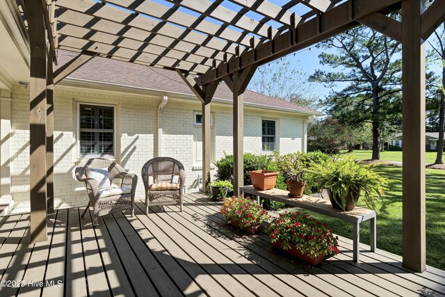 wooden terrace with a lawn and a pergola