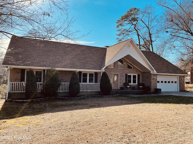 view of front facade featuring covered porch, a garage, brick siding, a shingled roof, and concrete driveway