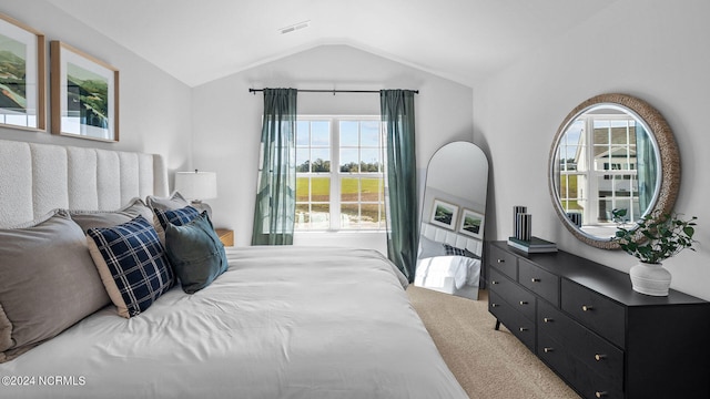 carpeted bedroom featuring lofted ceiling