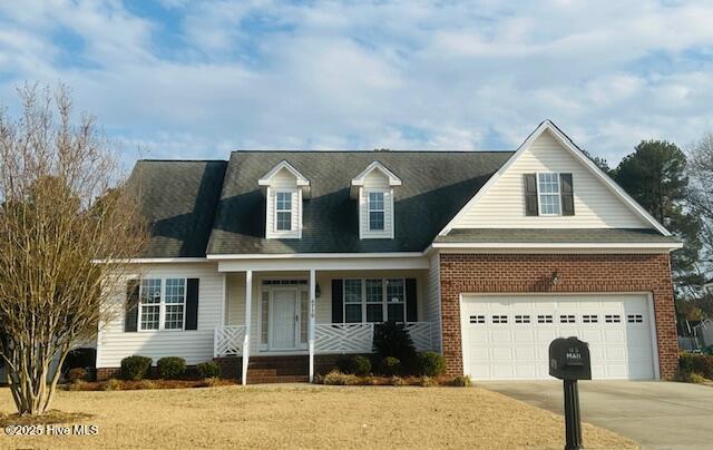 new england style home with a garage