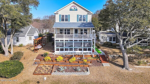 rear view of house with a vegetable garden