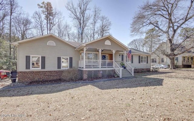 view of front of home with brick siding and covered porch