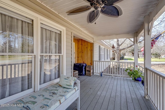 deck with a ceiling fan and covered porch