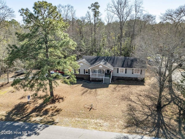 drone / aerial view featuring a view of trees