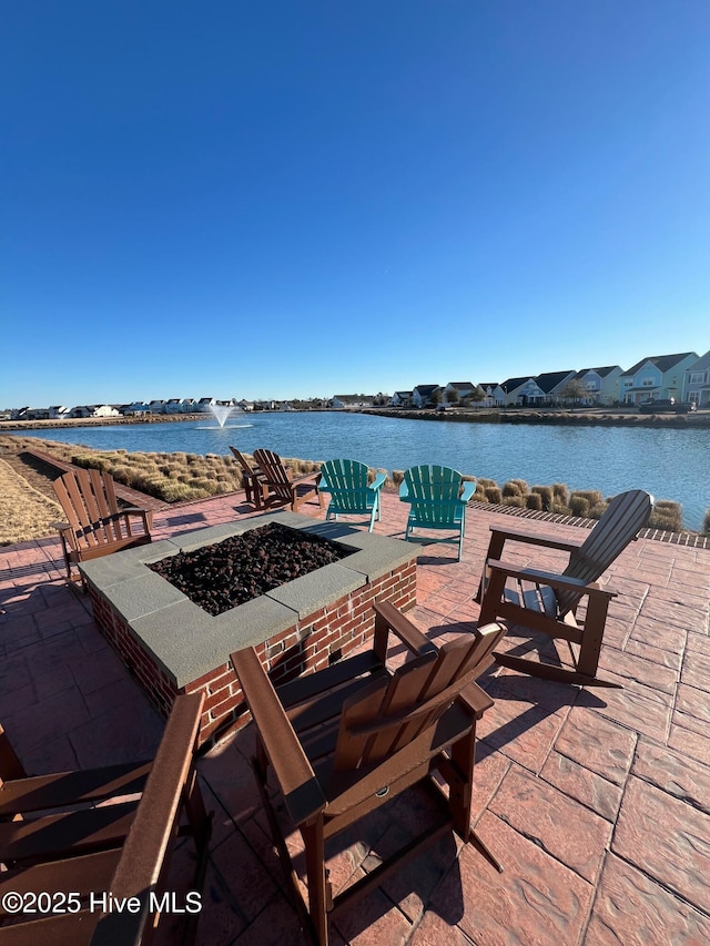 view of patio / terrace featuring a fire pit and a water view