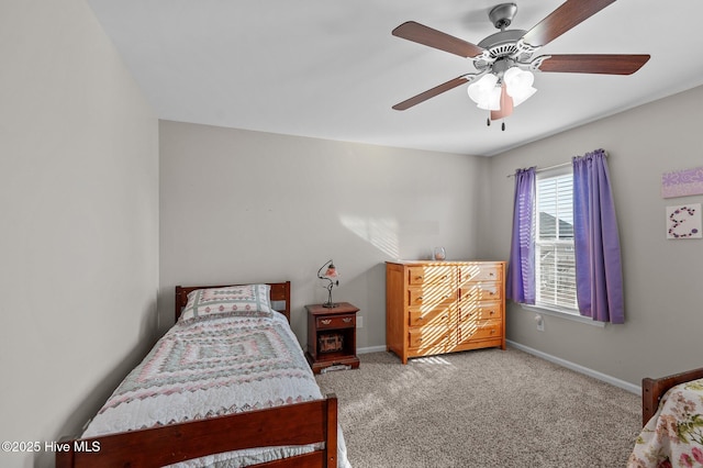 carpeted bedroom with a ceiling fan and baseboards