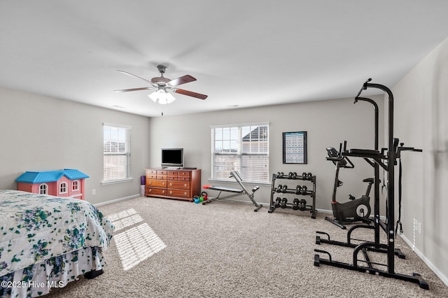 carpeted bedroom with ceiling fan and baseboards