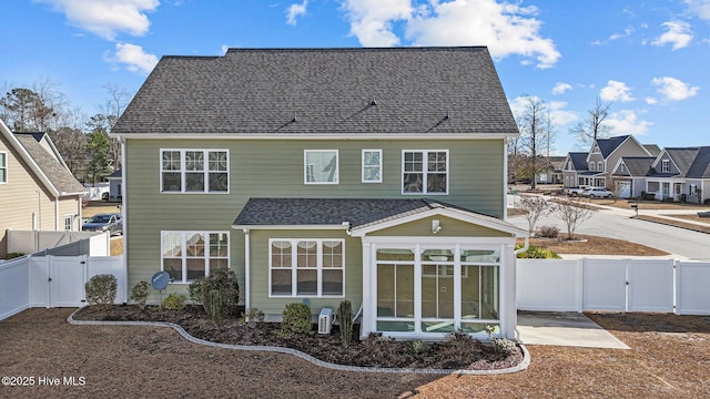 back of house featuring a sunroom