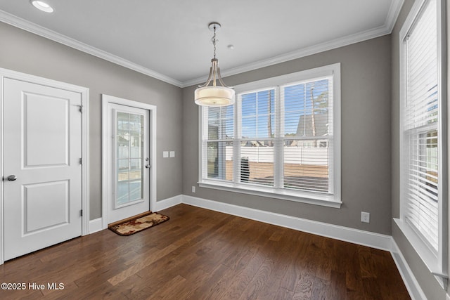 unfurnished dining area with ornamental molding and dark hardwood / wood-style floors